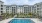 a swimming pool in front of a large building