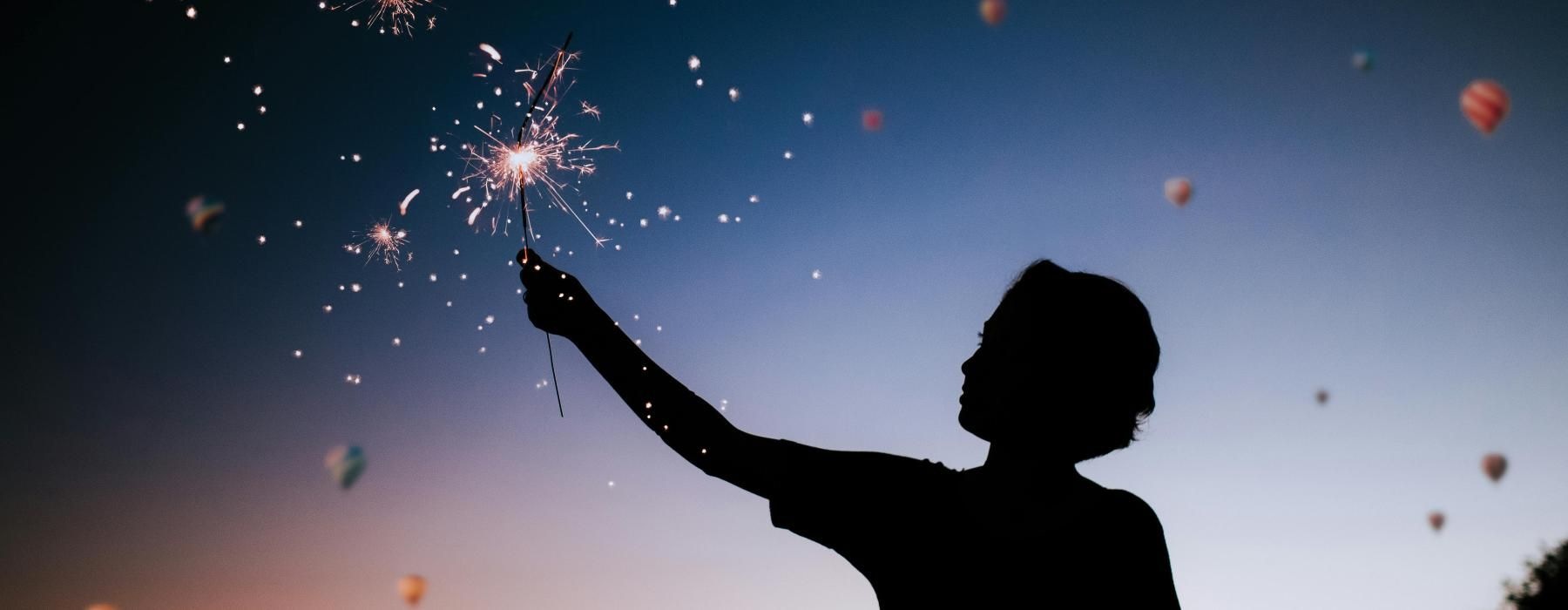 a person holding a sparkler