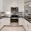 kitchen showing an island, bright lighting and modern appliances