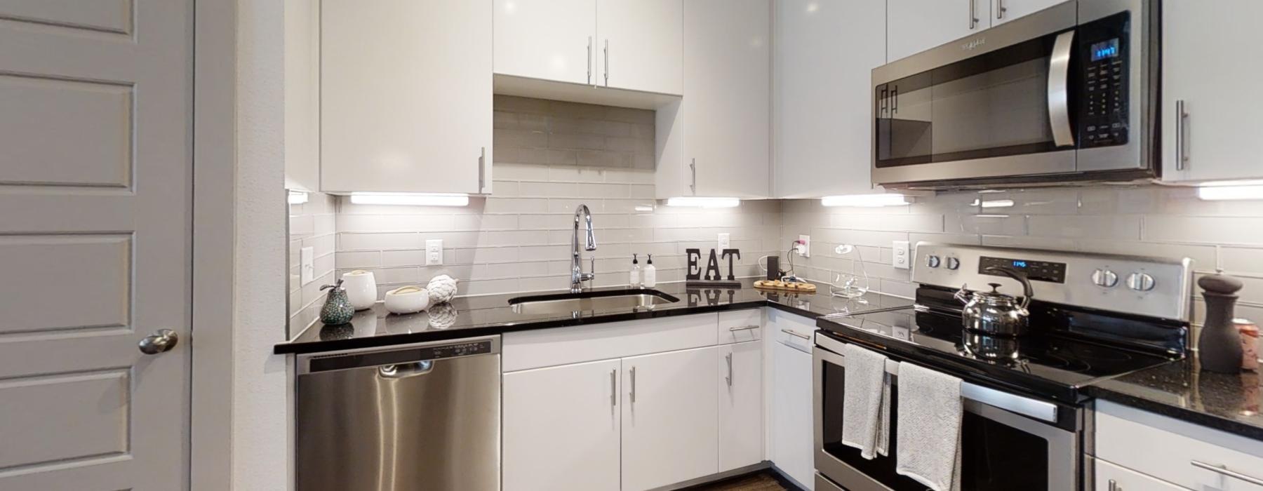 a kitchen with white cabinets