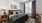 a bedroom with a bed and a chair