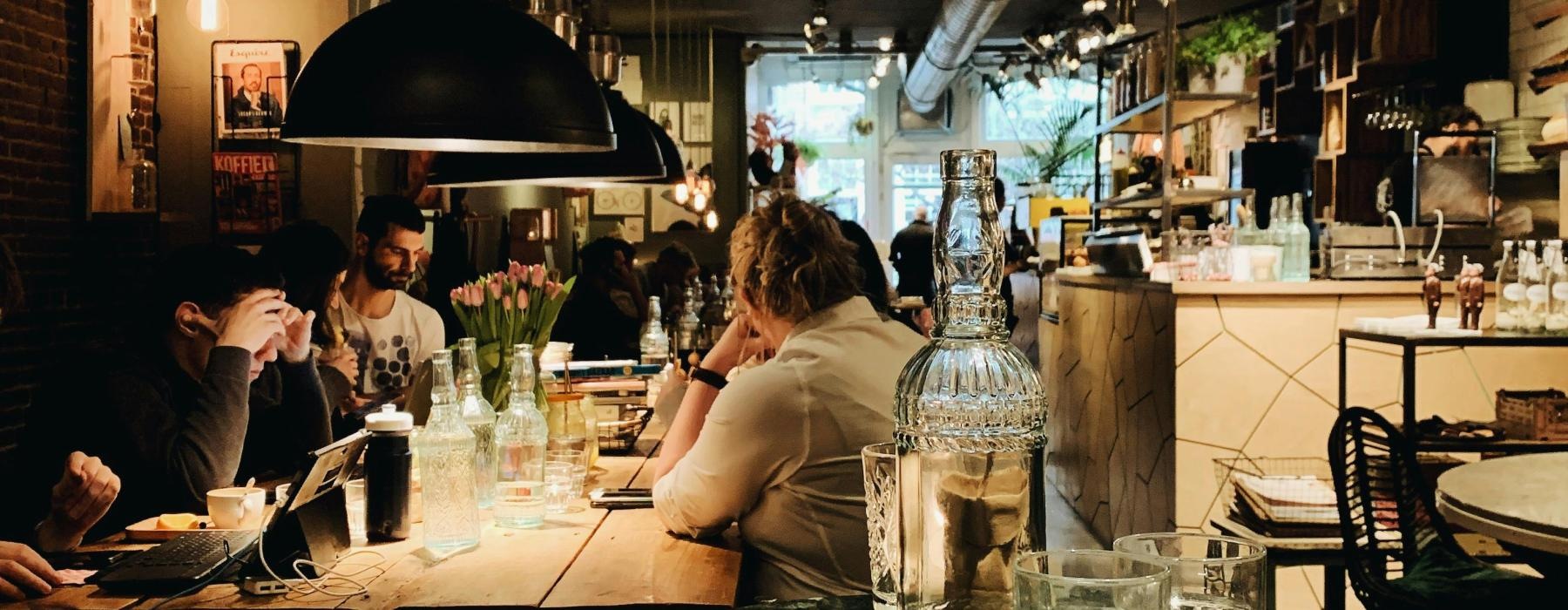 people sitting at tables in a restaurant