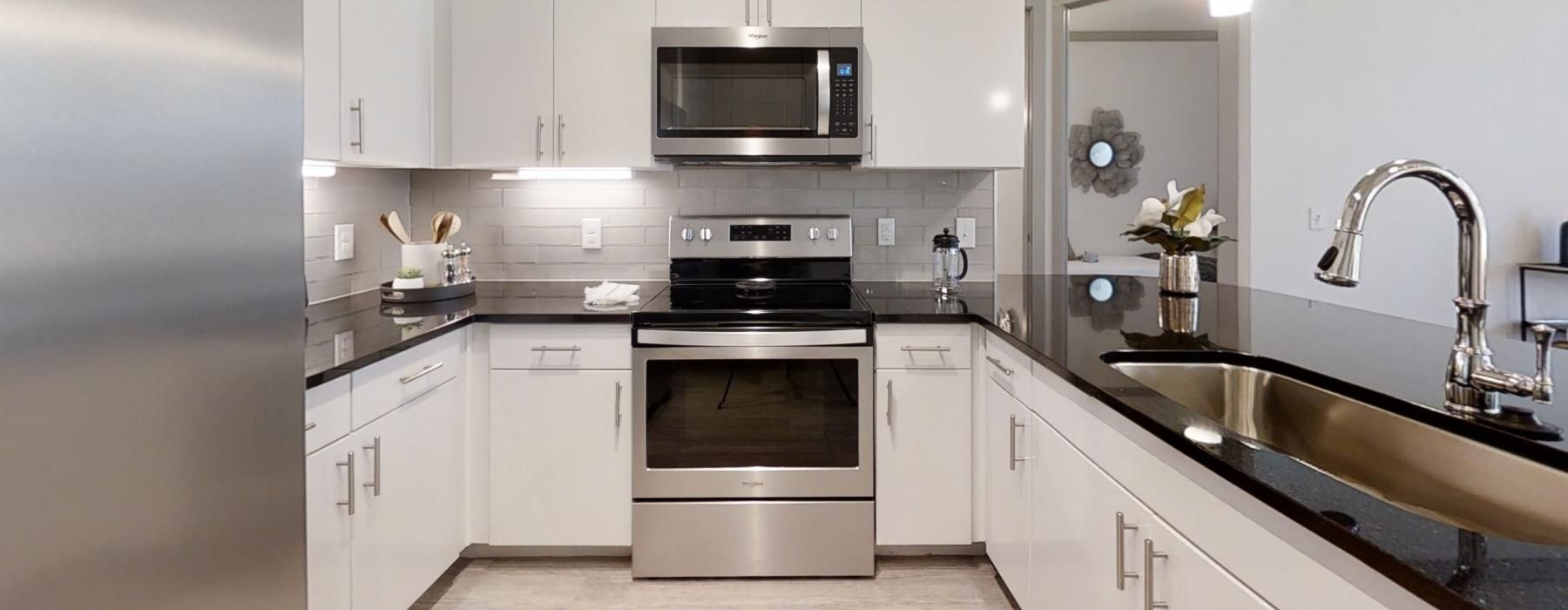a kitchen with white cabinets