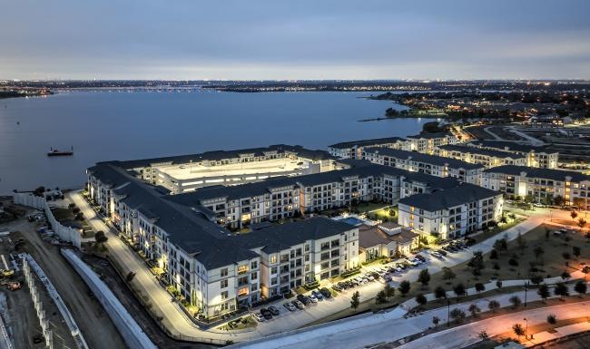 a large building with a body of water in the background