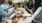 a group of people having a meal around an outdoor table